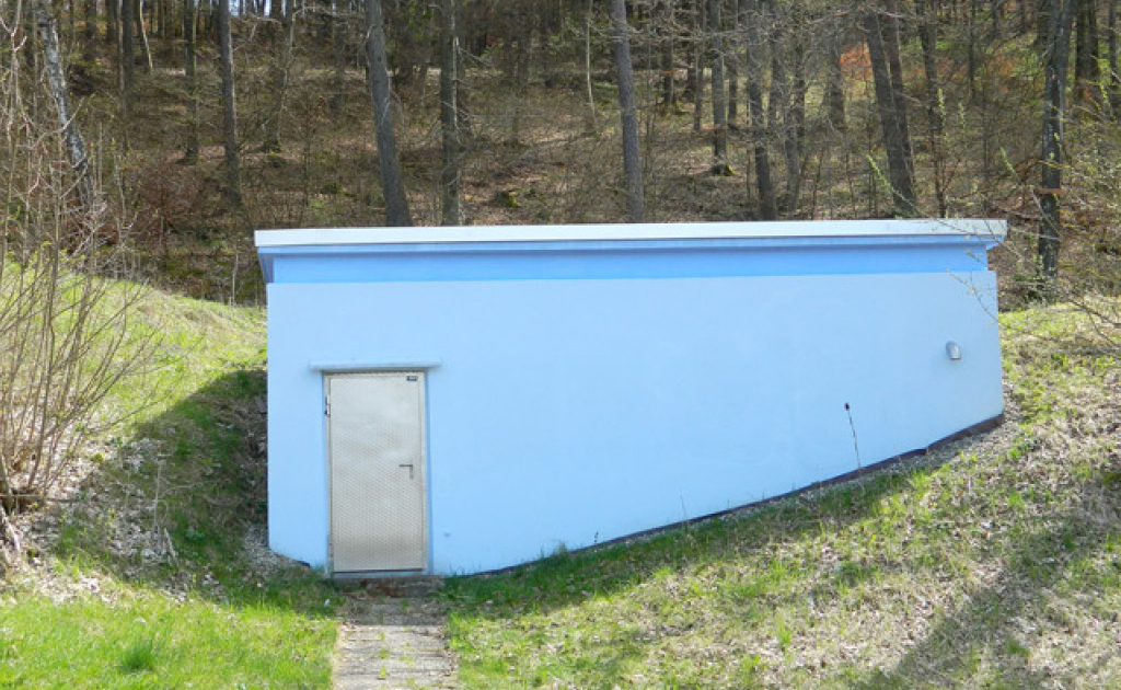Ein blaues Wasserhaus im Wald